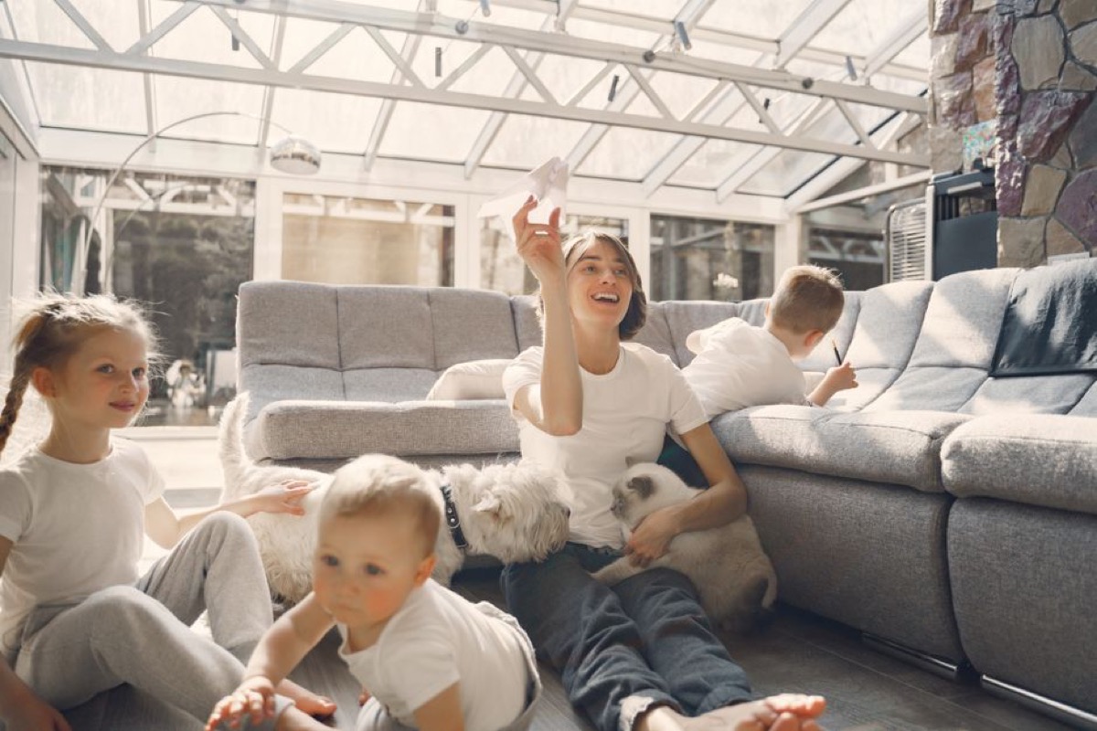 Family with children and a dog enjoying time at home in a bright living room