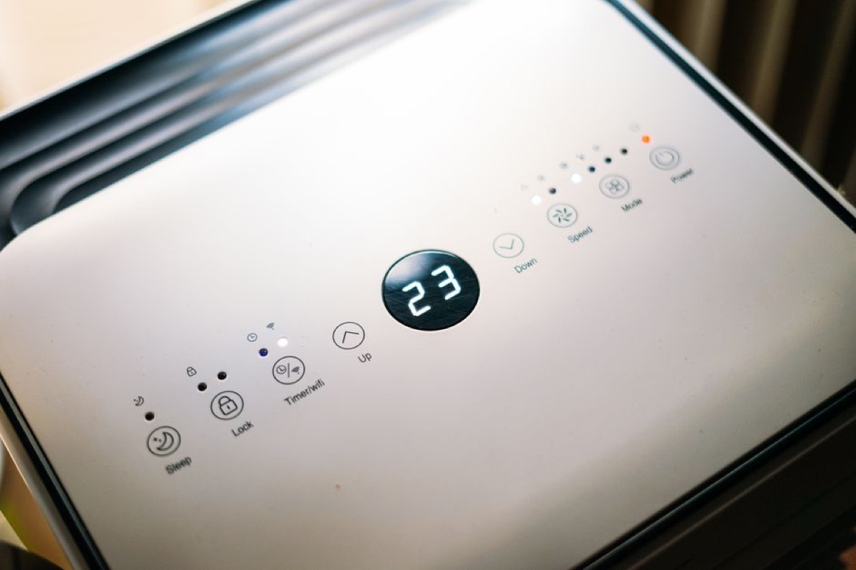 Close-up of a climate control panel showing air quality settings and temperature