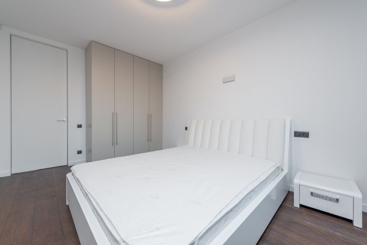Clean minimalist bedroom where air quality matters for sleep - choosing the right purifier for bedroom use